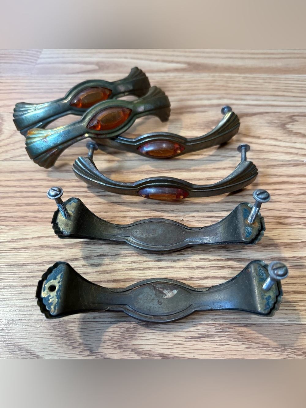 Vintage Art Deco style drawer pulls featuring amber-colored Bakelite inserts